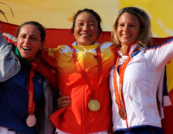 beijing_sensini_41.jpg - (From L) Silver medalist Alessandra Sensini of Italy, gold medalist Yin Jian of China and bronze medalist Bryony Shaw of Britain celebrate on the podium of the windsurfing RS:X  women's class at the 2008 Beijing Olympic Games on August 20, 2008 at the Olympic sailing center in Qingdao. AFP PHOTO/DON EMMERT (Photo credit should read DON EMMERT/AFP/Getty Images)