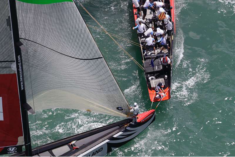 20090206-1318.jpg - Louis Vuitton Pacific Series 2009 Auckland, New Zealand. Team Origin hits the wands on the transom of BMW Oracle Racing during the pre start of day two of racing of Round Robin Two.  Credit Must Read:BOB GRIESER Outsideimages.co.nz